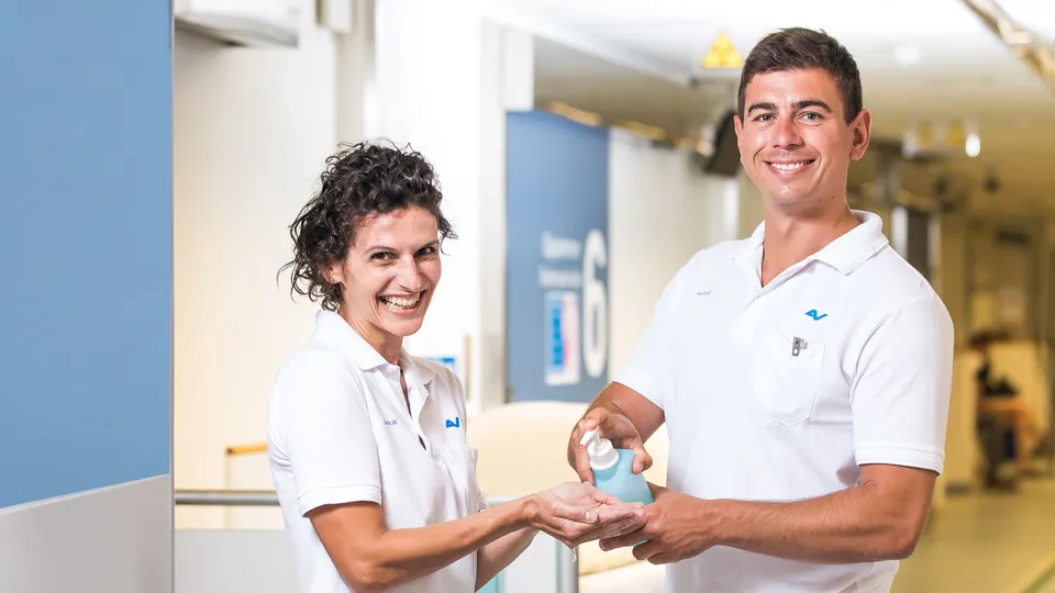 Zwei Personen aus dem Hygiene-Team des UK in Arbeitskleidung